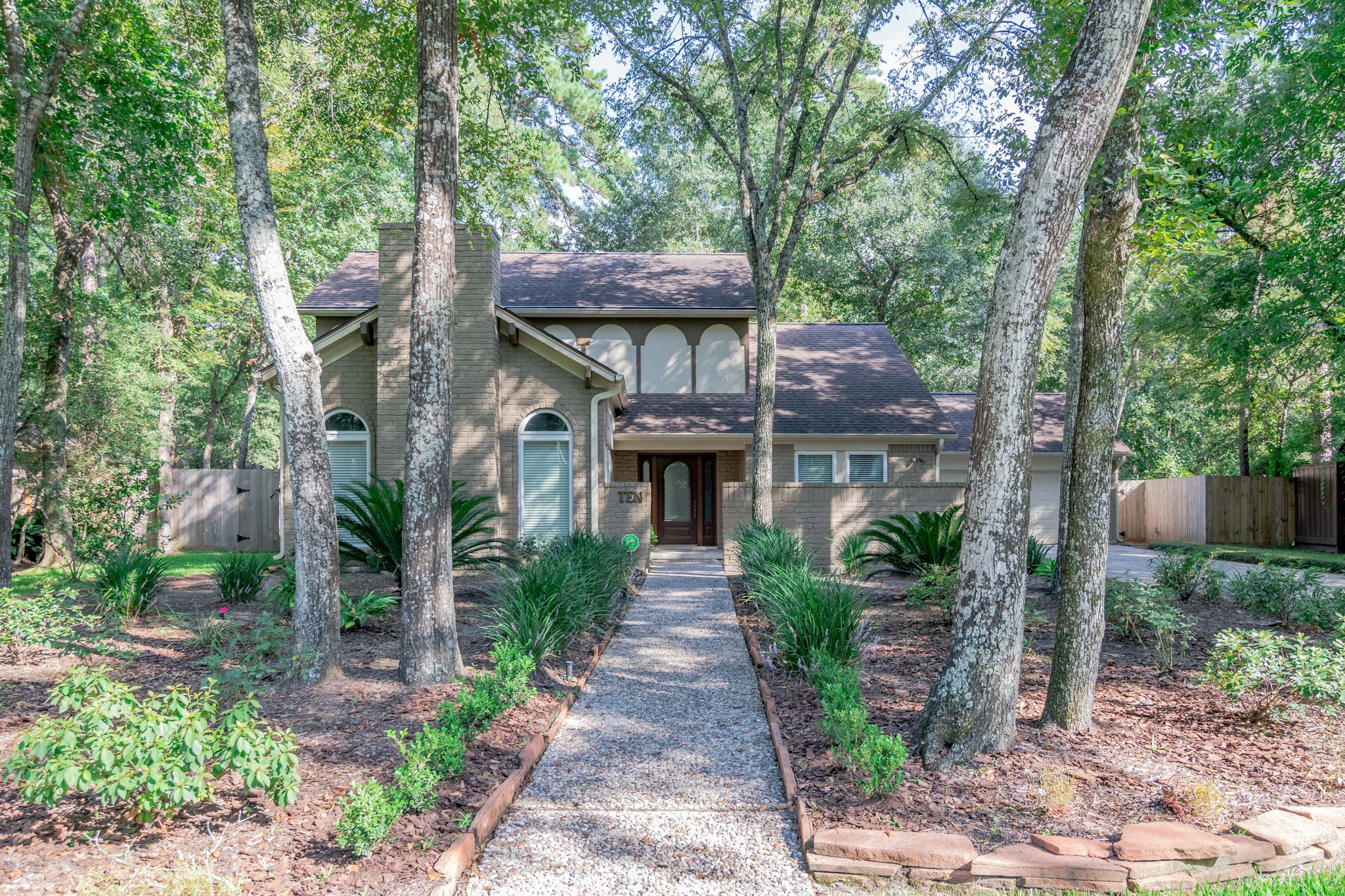 10 Coralvine Court Spring, TX 77380 - Photo 1 of 34 Updated family home has a welcoming presence tucked within beautiful mature trees with a lovely walkway.