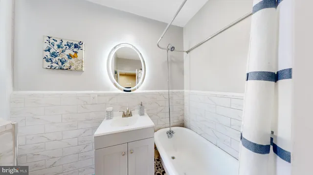a bathroom with a sink mirror and toilet