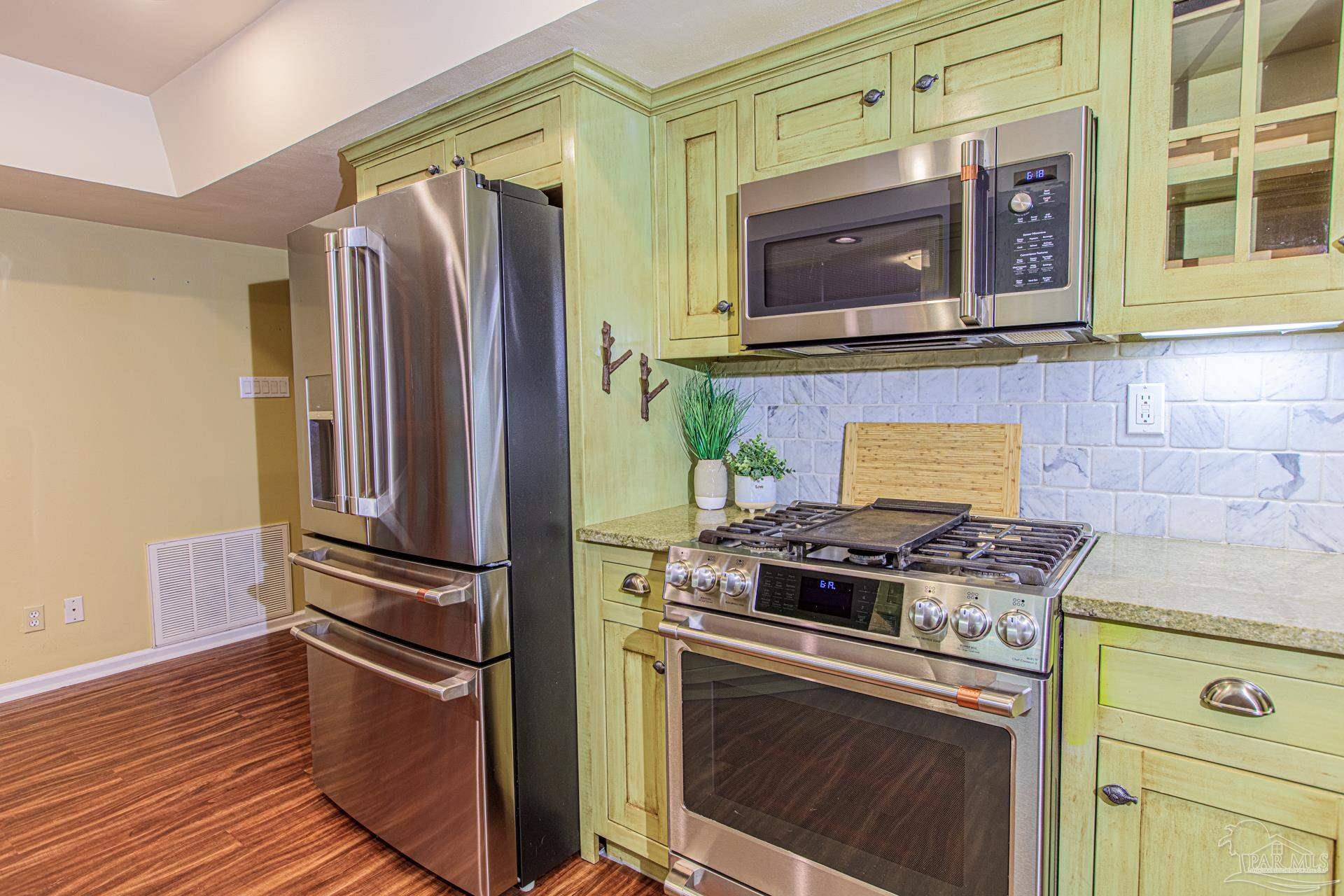 3777 Scenic Ridge Drive Pensacola, FL 32514 - Photo 11 of 67 a kitchen with stainless steel appliances granite countertop a stove and a refrigerator