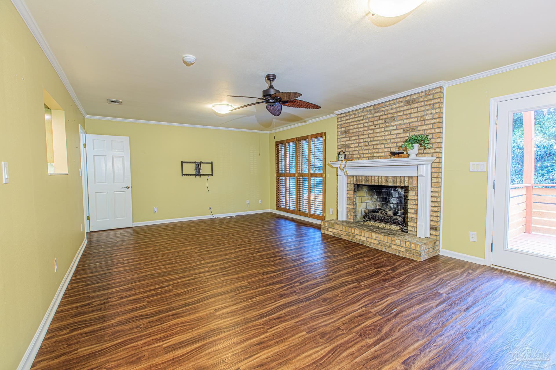 3777 Scenic Ridge Drive Pensacola, FL 32514 - Photo 24 of 67 a view of an empty room with wooden floor fireplace and a window