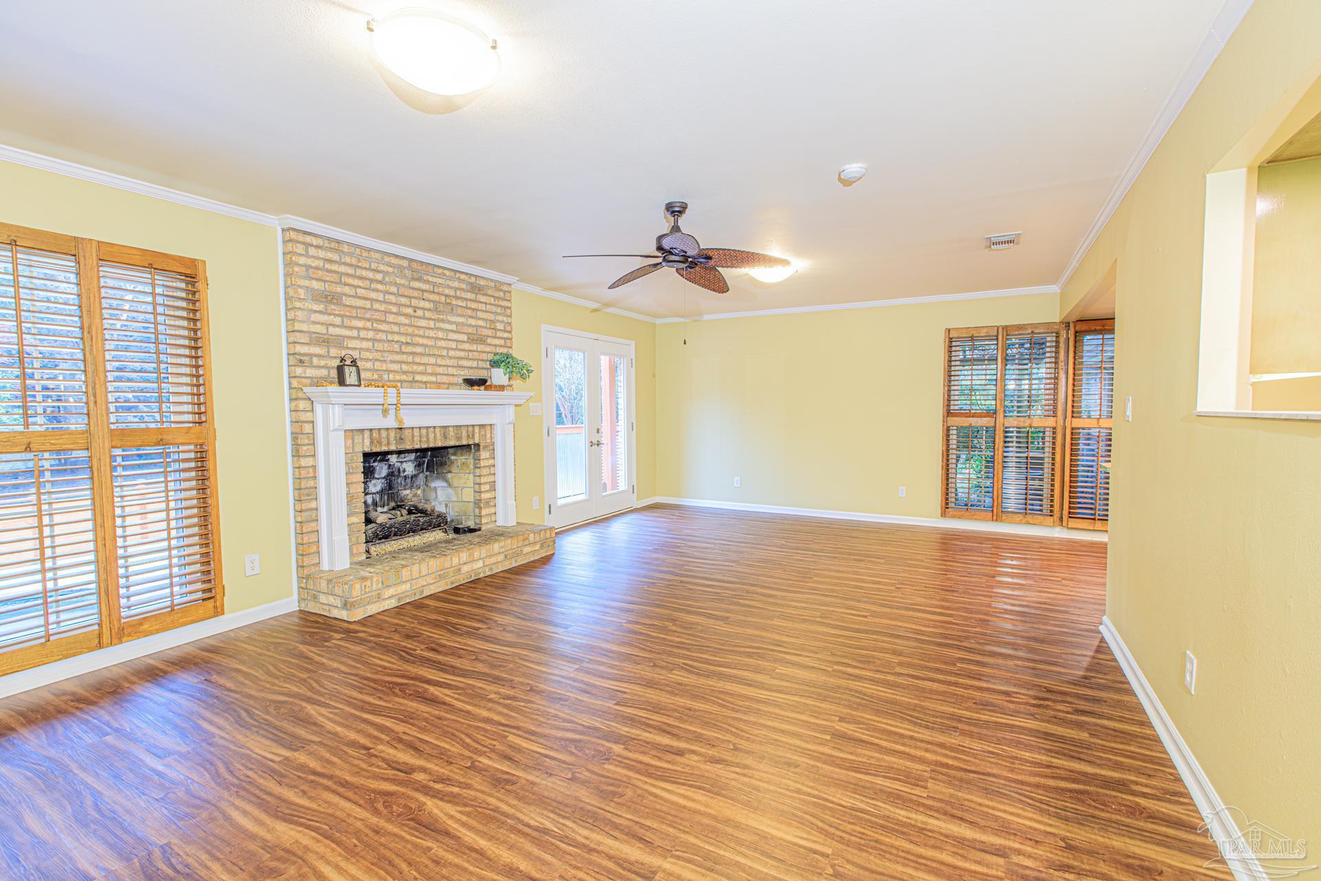 3777 Scenic Ridge Drive Pensacola, FL 32514 - Photo 25 of 67 a view of empty room with wooden floor and fireplace