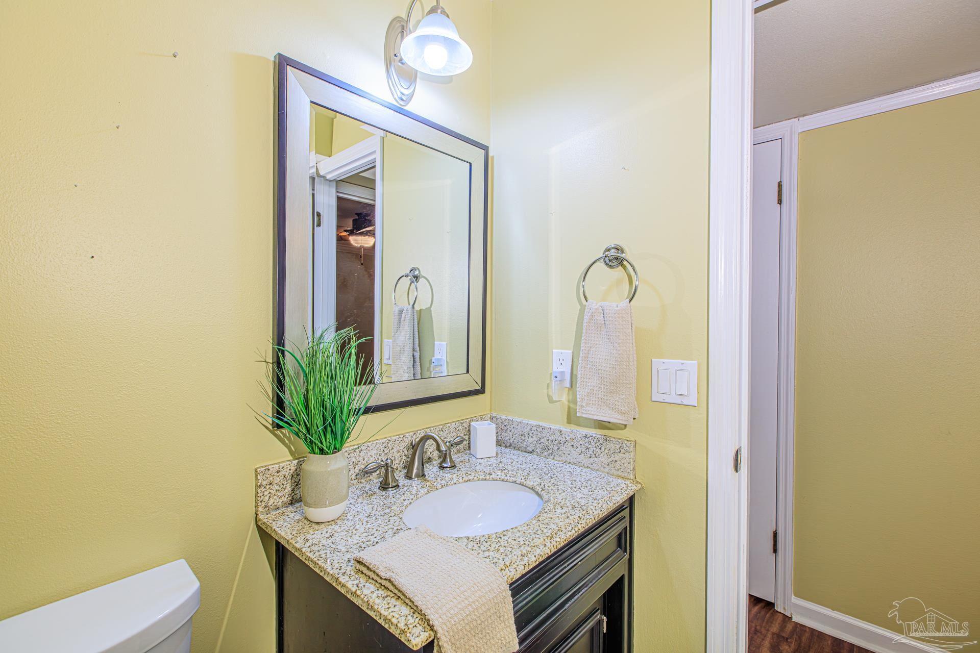 3777 Scenic Ridge Drive Pensacola, FL 32514 - Photo 30 of 67 a bathroom with a granite countertop sink and a mirror