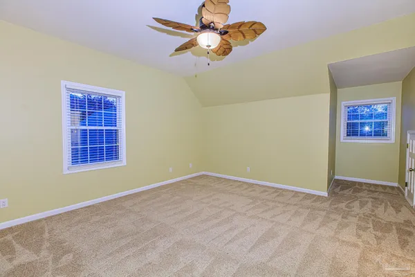 a view of a room with wooden floor and fan