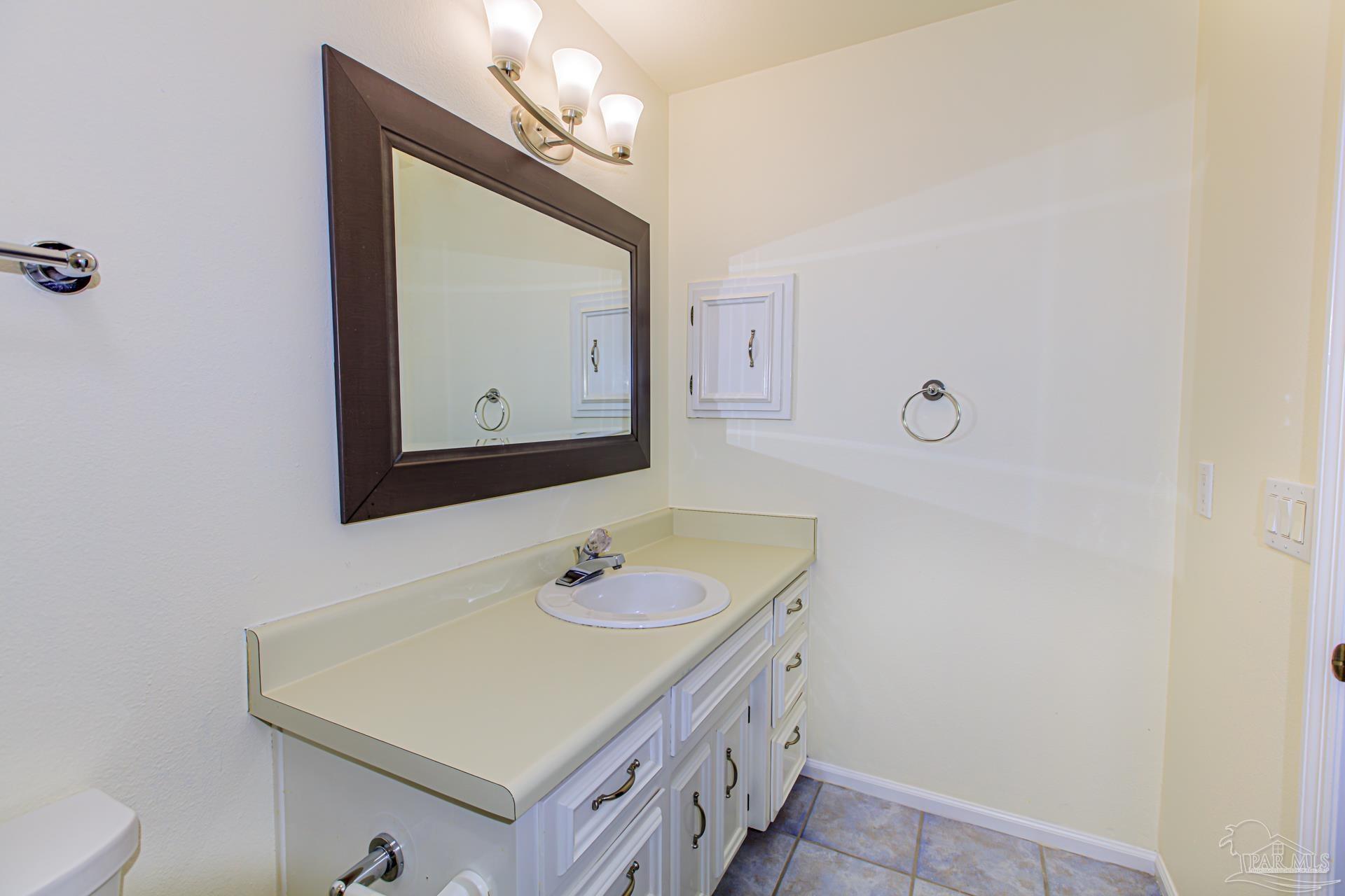 3777 Scenic Ridge Drive Pensacola, FL 32514 - Photo 35 of 67 a bathroom with a sink vanity and a mirror