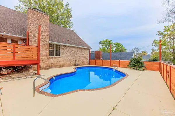 an aerial view of a house with swimming pool and porch
