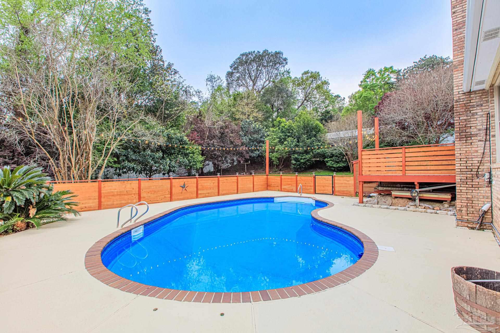 3777 Scenic Ridge Drive Pensacola, FL 32514 - Photo 50 of 67 a view of a swimming pool with an outdoor space and seating area