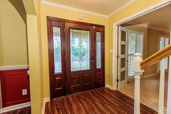 a view of a hallway with wooden floor and staircase