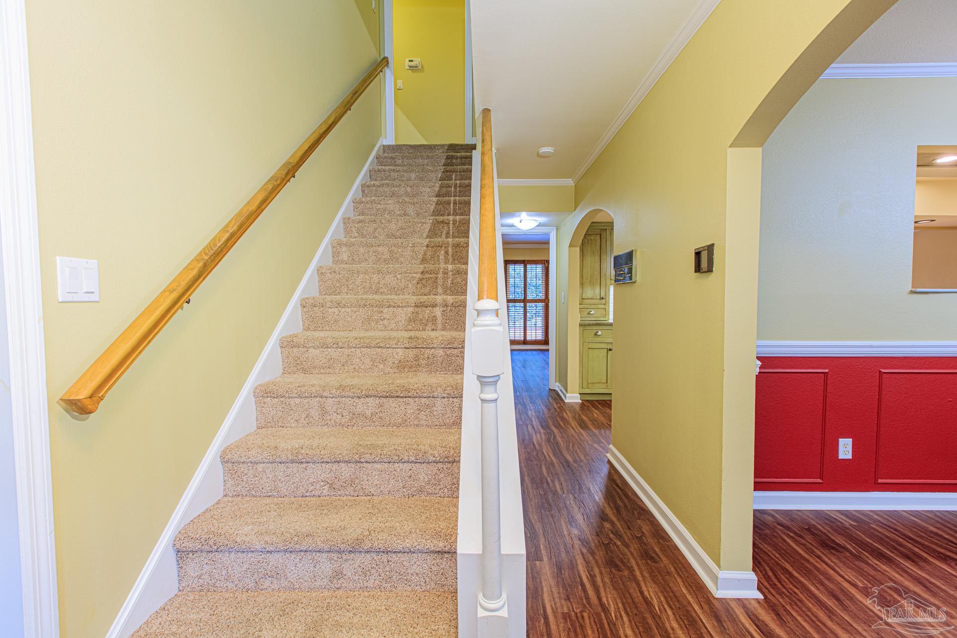 3777 Scenic Ridge Drive Pensacola, FL 32514 - Photo 6 of 67 a view of a hallway with wooden floor and staircase