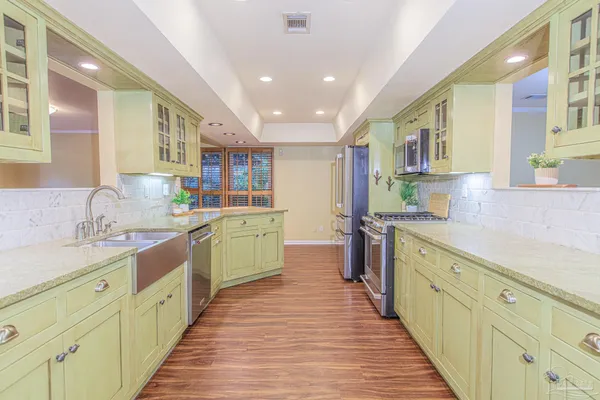 a kitchen with stainless steel appliances granite countertop a stove and a sink