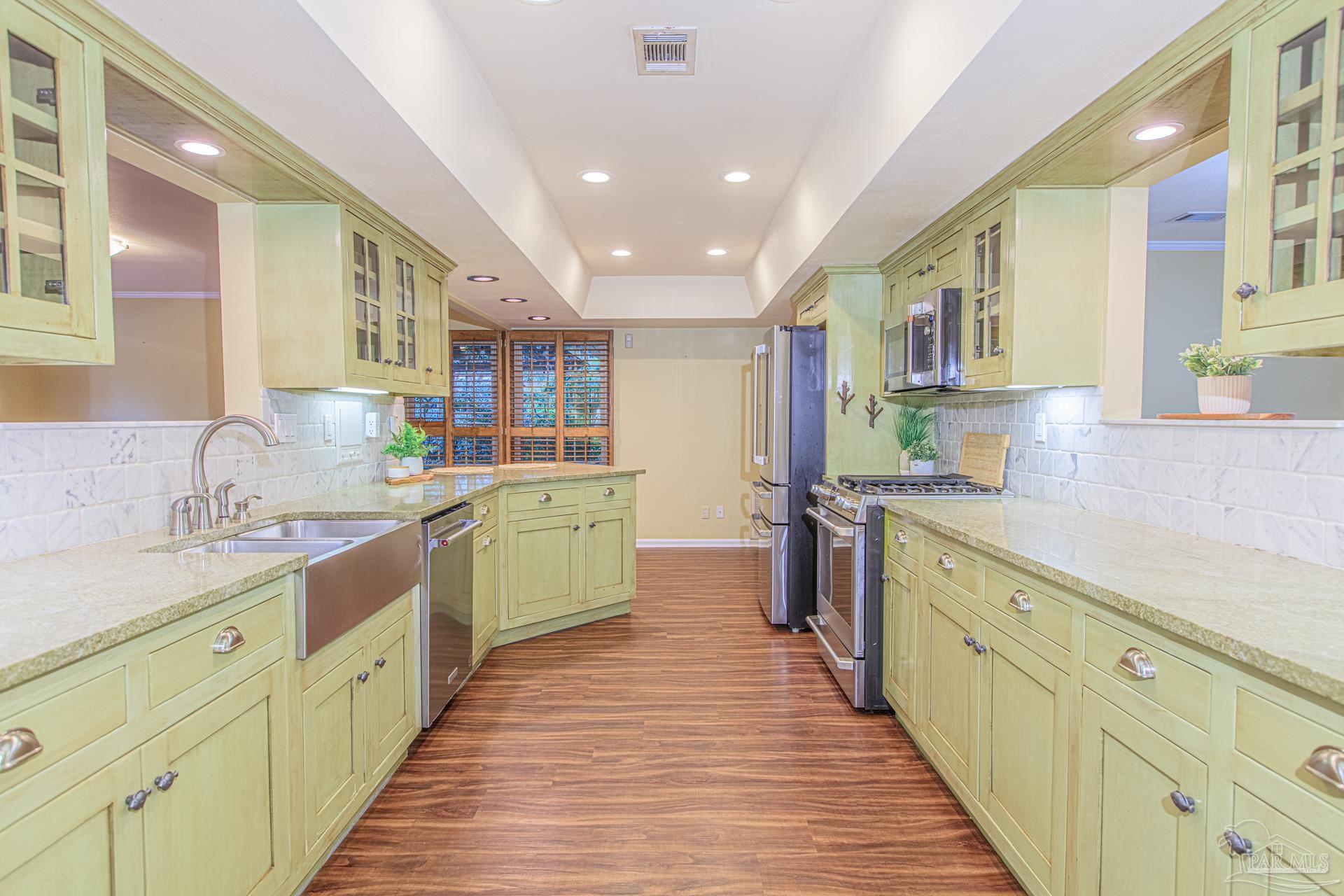 3777 Scenic Ridge Drive Pensacola, FL 32514 - Photo 9 of 67 a view of a kitchen with a sink and wooden cabinets