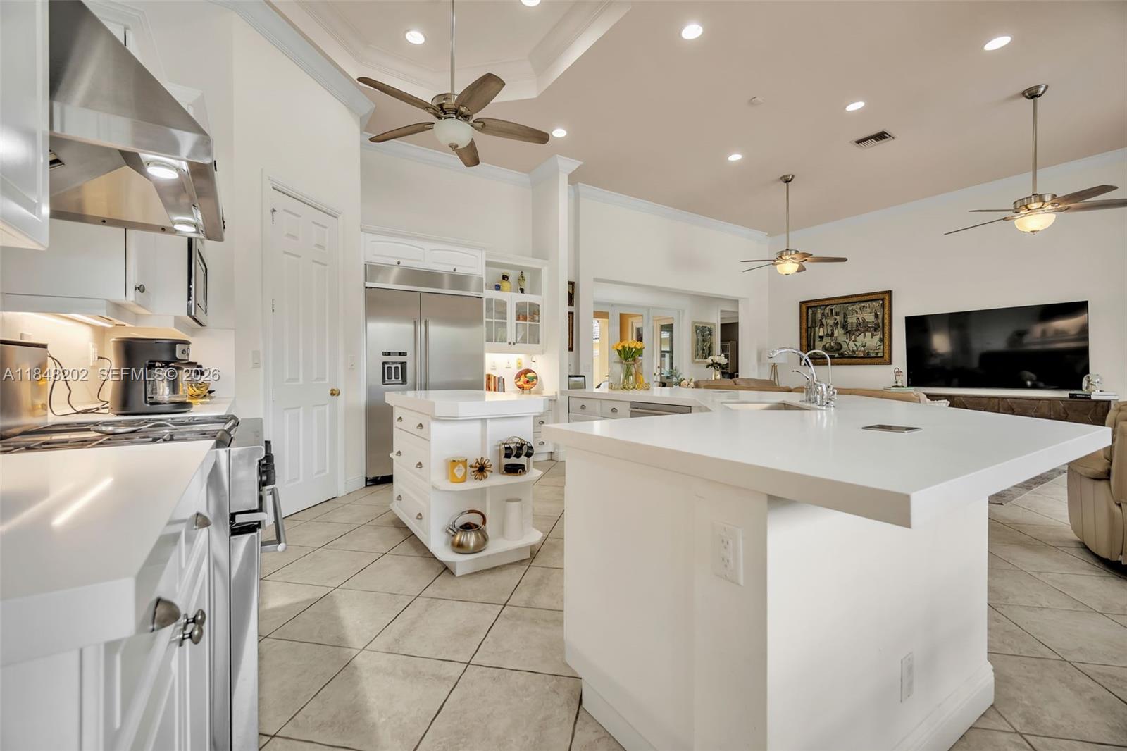 14211 Southwest 63rd Street Southwest Ranches, FL 33330 - Photo 12 of 81 a kitchen with kitchen island a sink appliances and cabinets