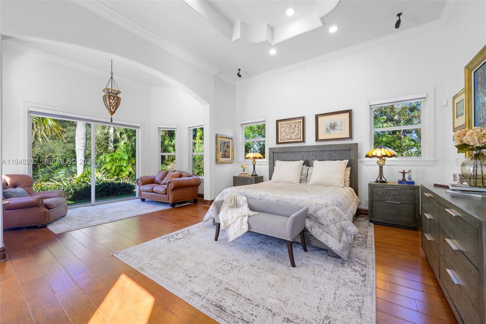 14211 Southwest 63rd Street Southwest Ranches, FL 33330 - Photo 27 of 81 a spacious bedroom with a bed a couch and a large window