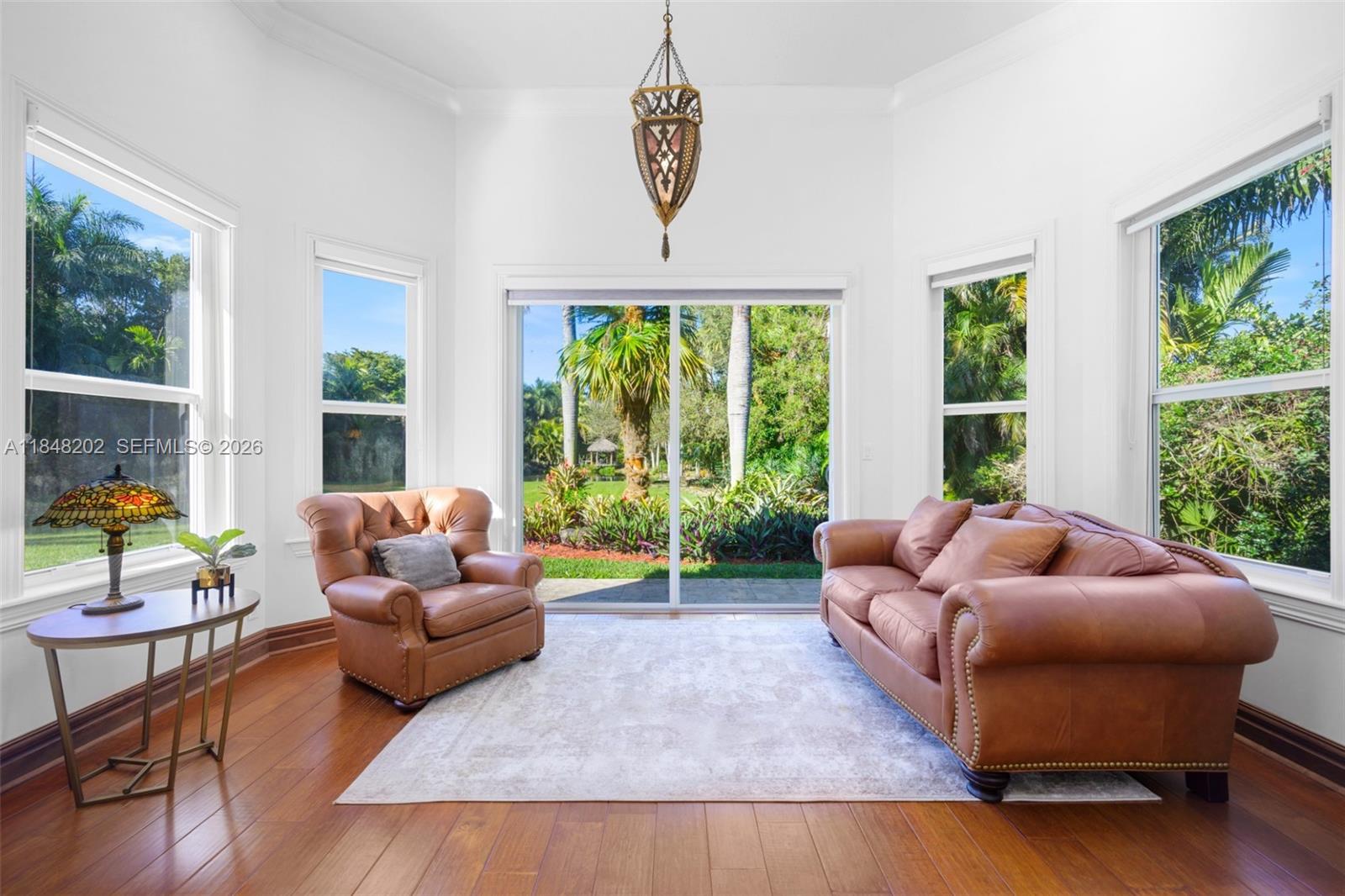 14211 Southwest 63rd Street Southwest Ranches, FL 33330 - Photo 31 of 81 a living room with furniture and a large window
