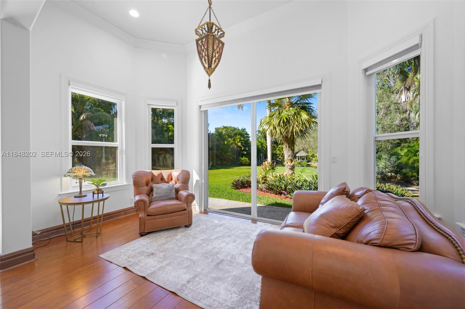 14211 Southwest 63rd Street Southwest Ranches, FL 33330 - Photo 32 of 81 a living room with furniture and a large window