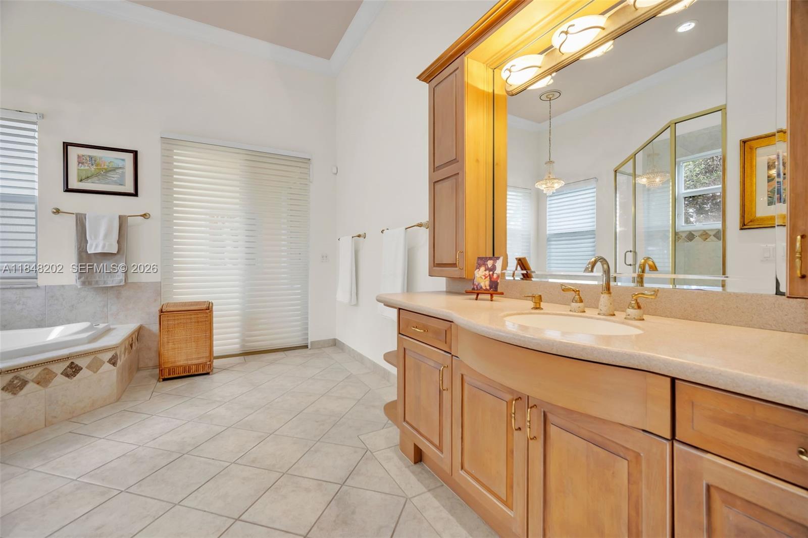 14211 Southwest 63rd Street Southwest Ranches, FL 33330 - Photo 33 of 81 a bathroom with a granite countertop sink a toilet a mirror and bathtub