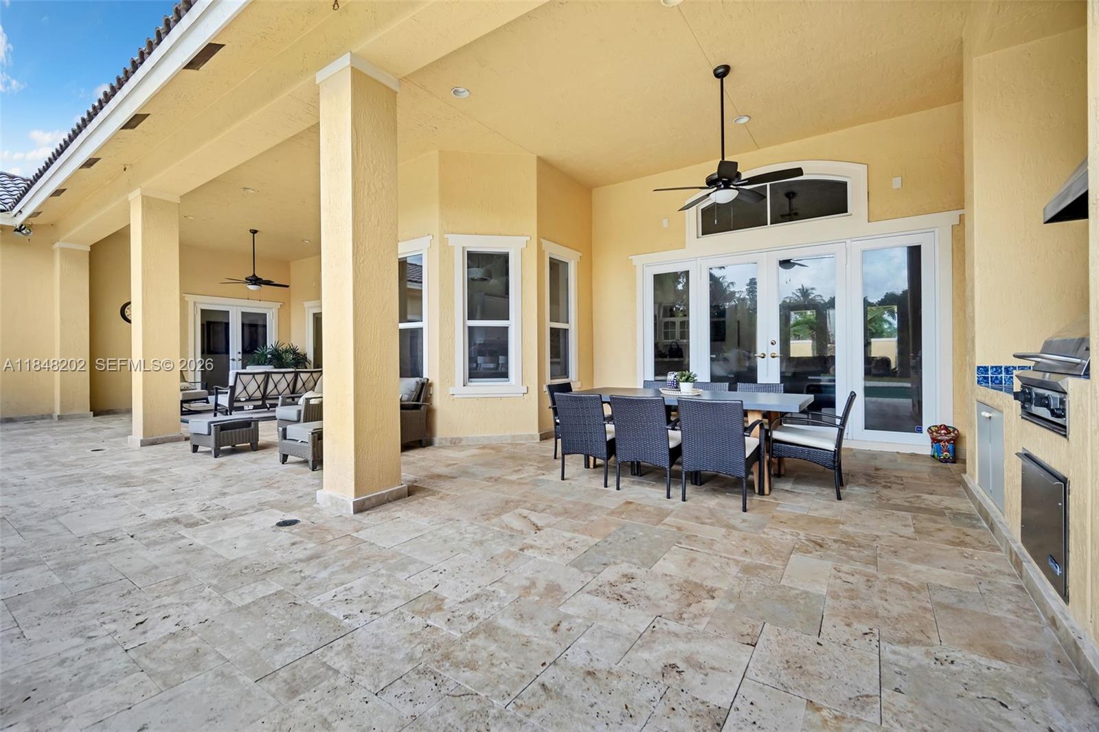 14211 Southwest 63rd Street Southwest Ranches, FL 33330 - Photo 53 of 81 a view of a livingroom with furniture a flat screen tv and outdoor seating