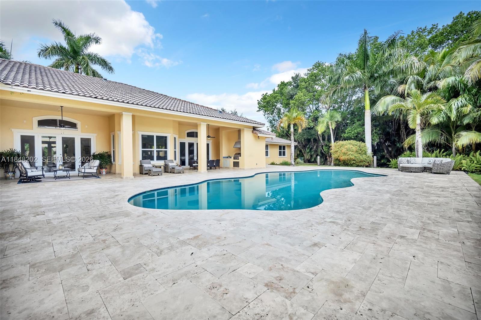 14211 Southwest 63rd Street Southwest Ranches, FL 33330 - Photo 55 of 81 a view of a house with a swimming pool