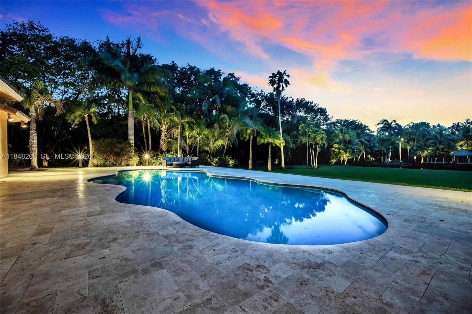 14211 Southwest 63rd Street Southwest Ranches, FL 33330 - Photo 56 of 81 a view of a swimming pool with a yard