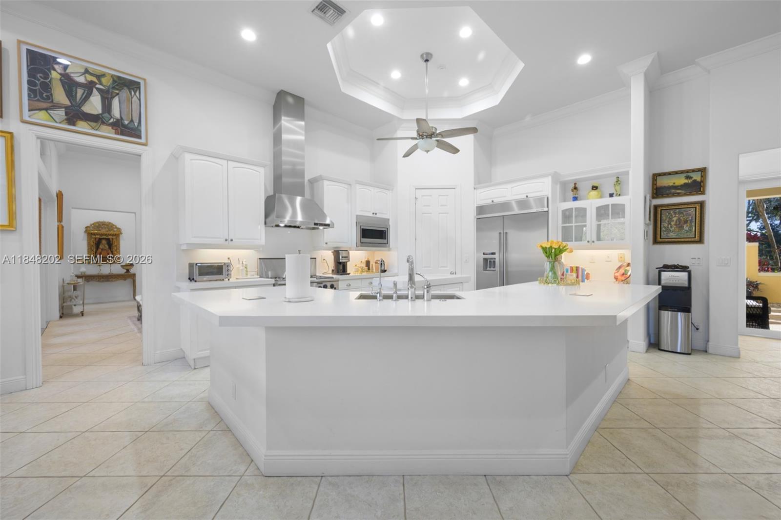 14211 Southwest 63rd Street Southwest Ranches, FL 33330 - Photo 10 of 81 a view of living room with stainless steel appliances furniture a chandelier and kitchen view