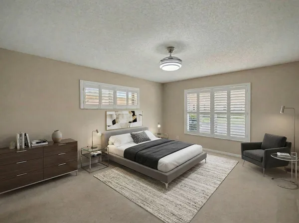 a spacious bedroom with a bed and a couch