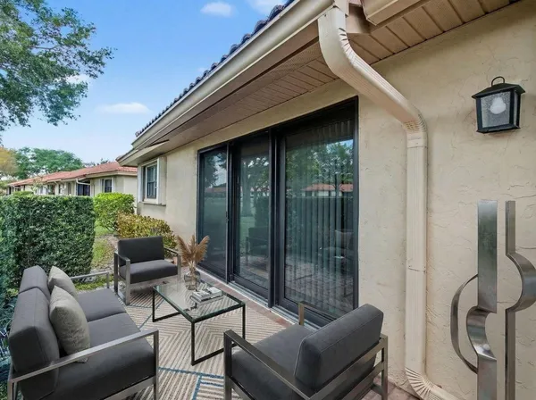 a balcony with furniture and a potted plant