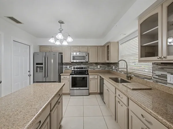 a kitchen with a sink stove and refrigerator