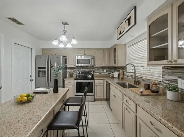 a kitchen with furniture a counter space and stainless steel appliances