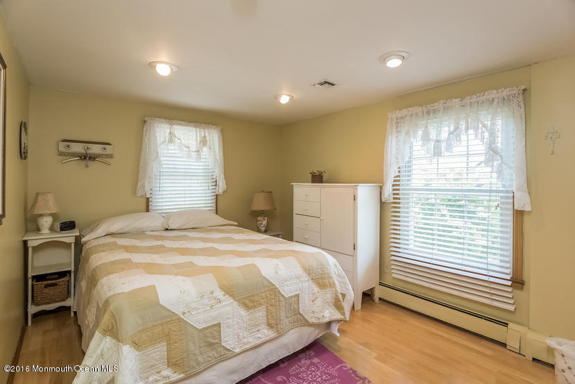 737 Wall Road Spring Lake Heights, NJ 07762 - Photo 16 of 26 a bedroom with a bed and wooden floor