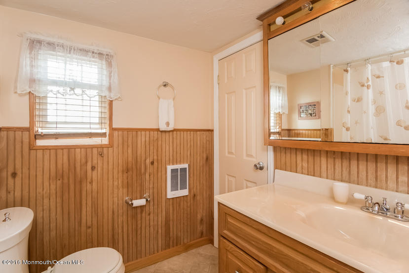 737 Wall Road Spring Lake Heights, NJ 07762 - Photo 18 of 26 a bathroom with a sink a toilet and mirror