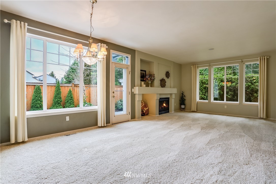 672 Chelan Place Northeast Renton, WA 98059 - Photo 4 of 24 a view of an empty room with a fireplace and a window