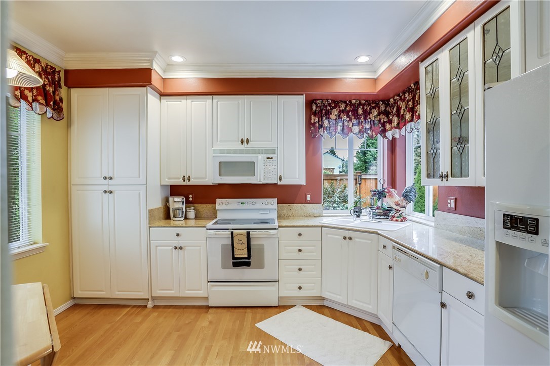 672 Chelan Place Northeast Renton, WA 98059 - Photo 9 of 24 a kitchen with a sink cabinets and wooden floor