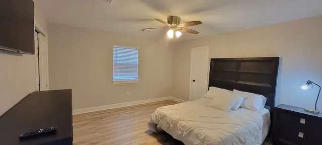 a bedroom with a bed and a chandelier