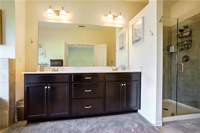 a bathroom with a sink vanity and a mirror