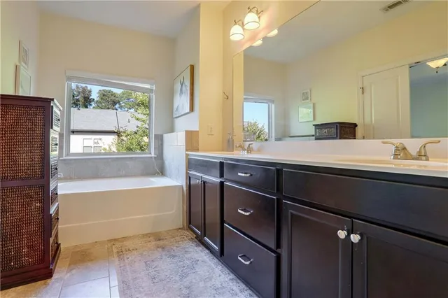 a bathroom with a tub sink and a mirror