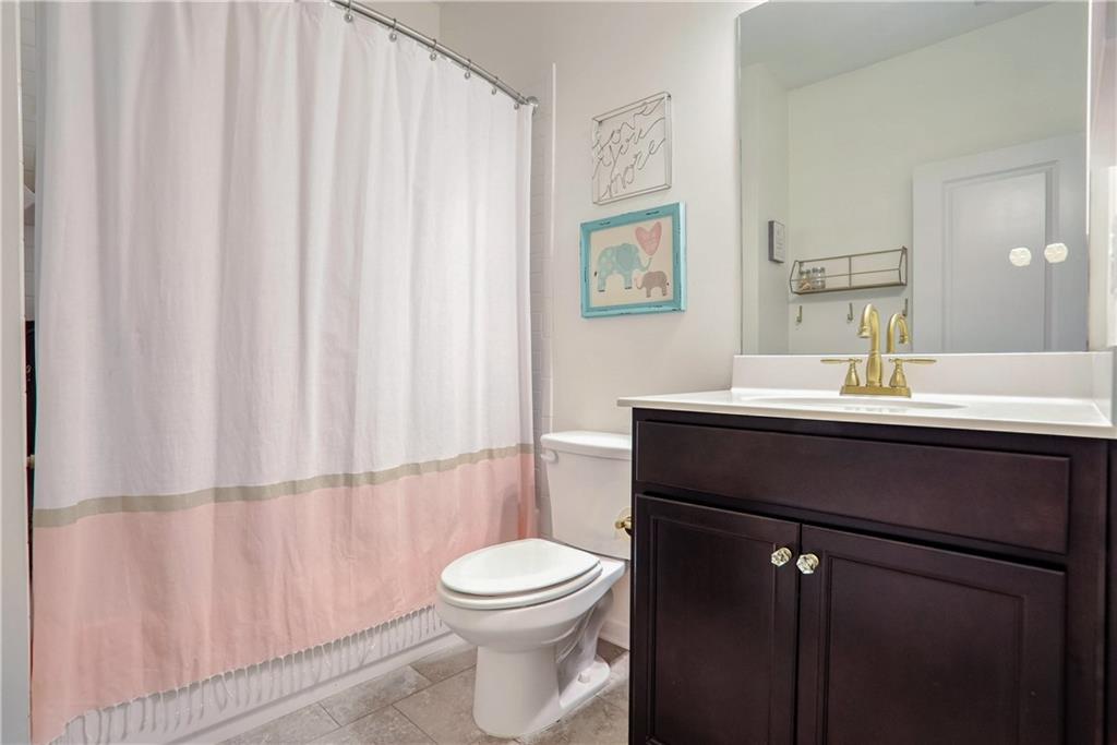 3216 Creole Lane Decatur, GA 30032 - Photo 16 of 25 a bathroom with a sink a toilet and shower curtain