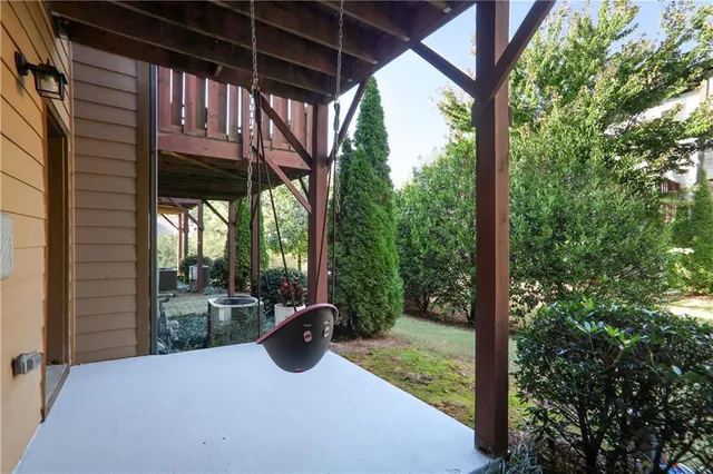 a view of a porch with furniture and a yard