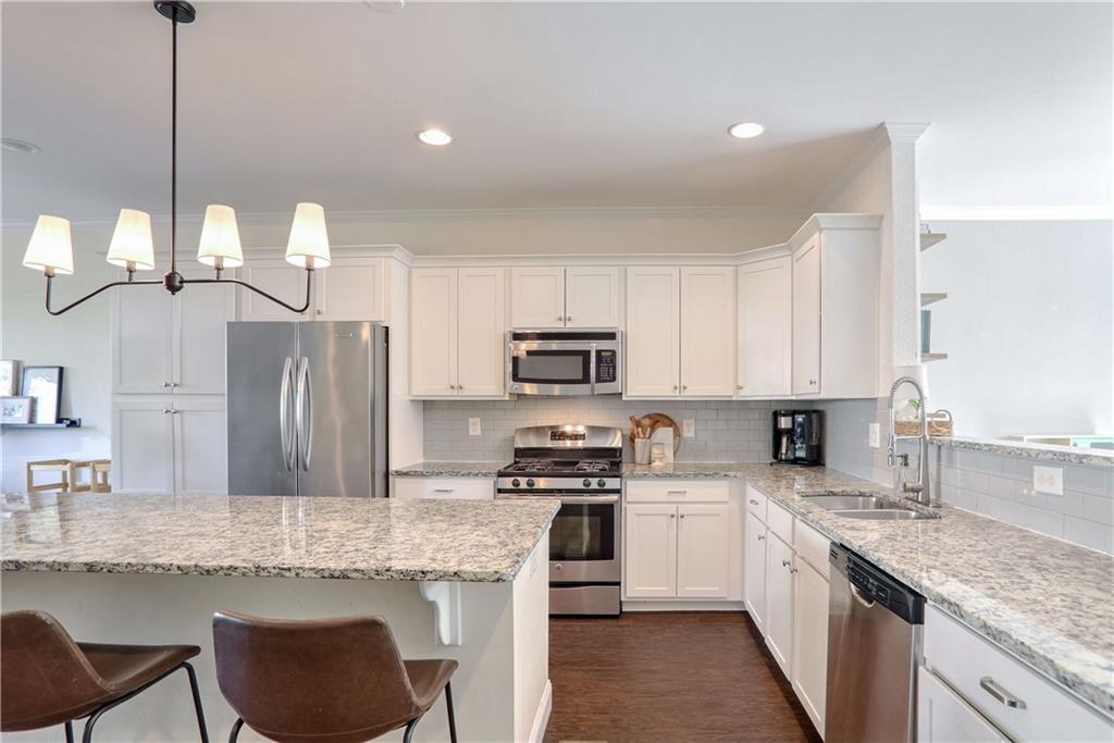 3216 Creole Lane Decatur, GA 30032 - Photo 3 of 25 a kitchen with granite countertop a sink a counter top space appliances and cabinets