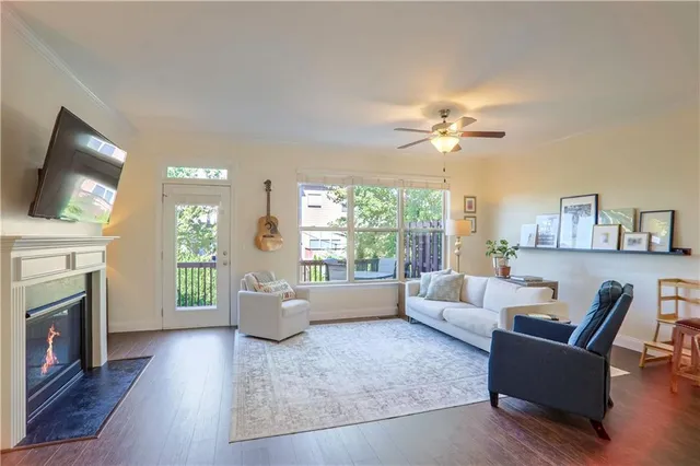 a living room with furniture a fireplace and a flat screen tv