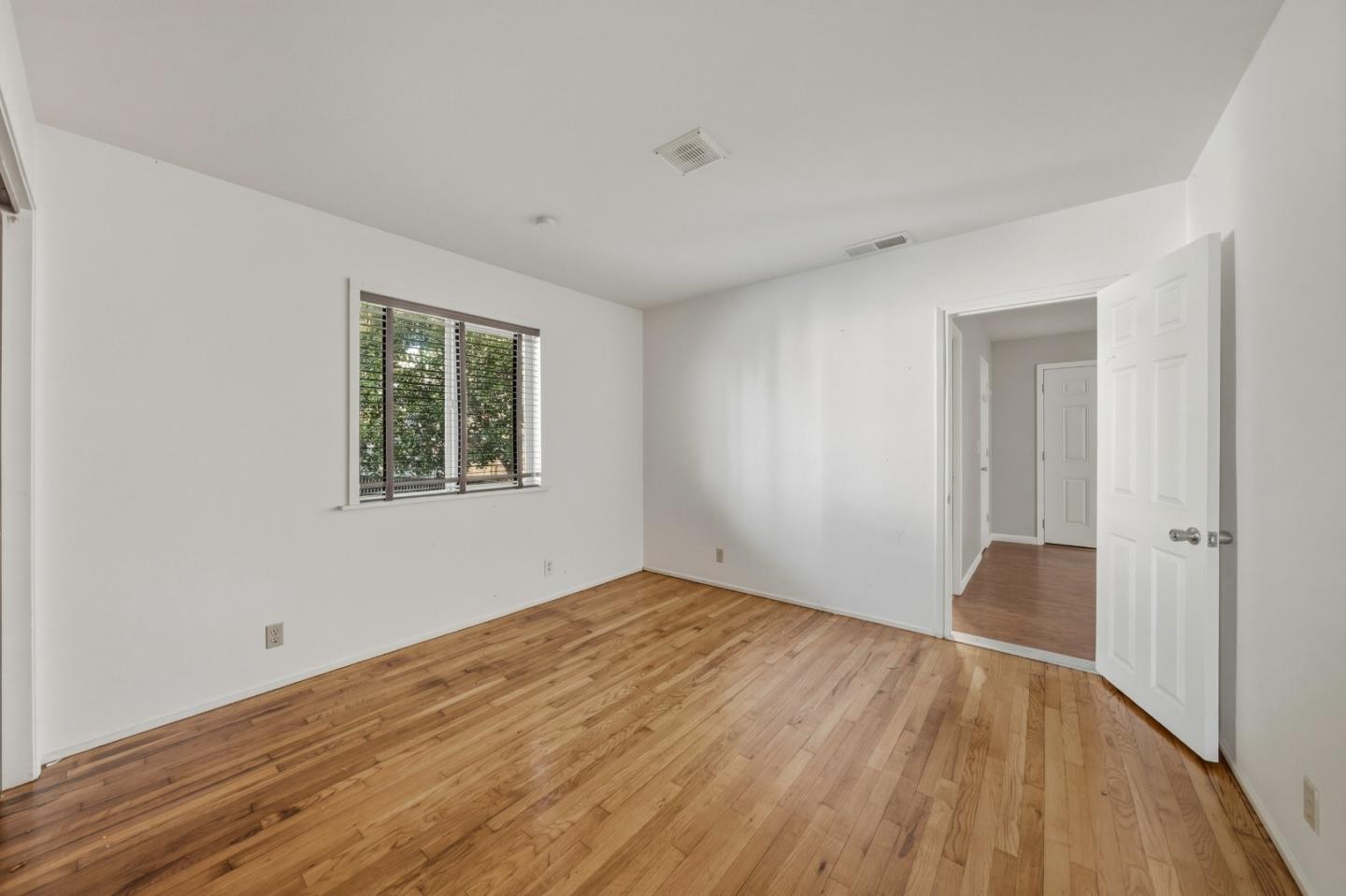 13590 Fair Oak Road Clearlake, CA 95422 - Photo 14 of 27 a view of an empty room with wooden floor and a window