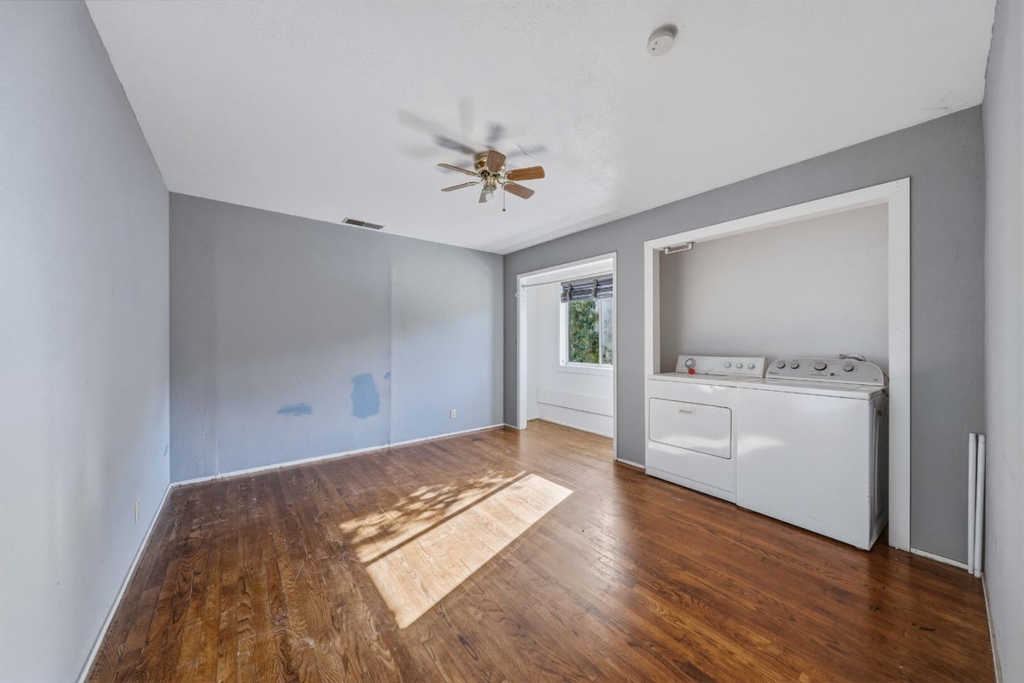 13590 Fair Oak Road Clearlake, CA 95422 - Photo 16 of 27 wooden floor in an empty room with a window