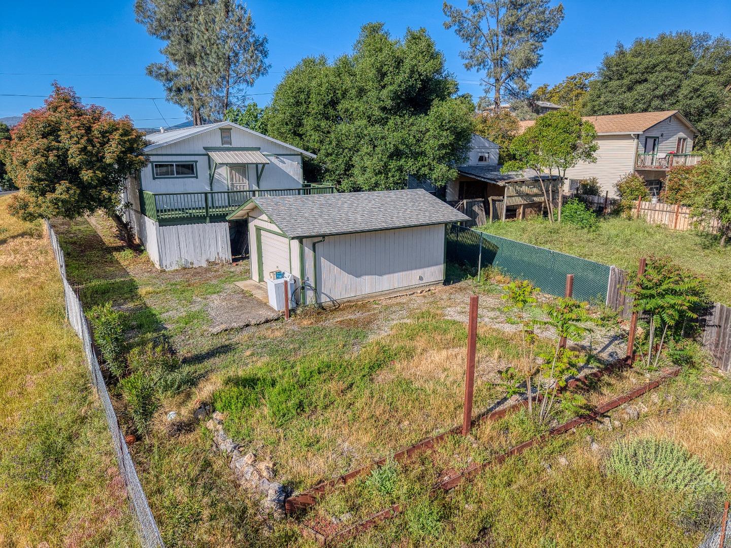 13590 Fair Oak Road Clearlake, CA 95422 - Photo 24 of 27 a view of house with backyard outdoor seating and hardwood