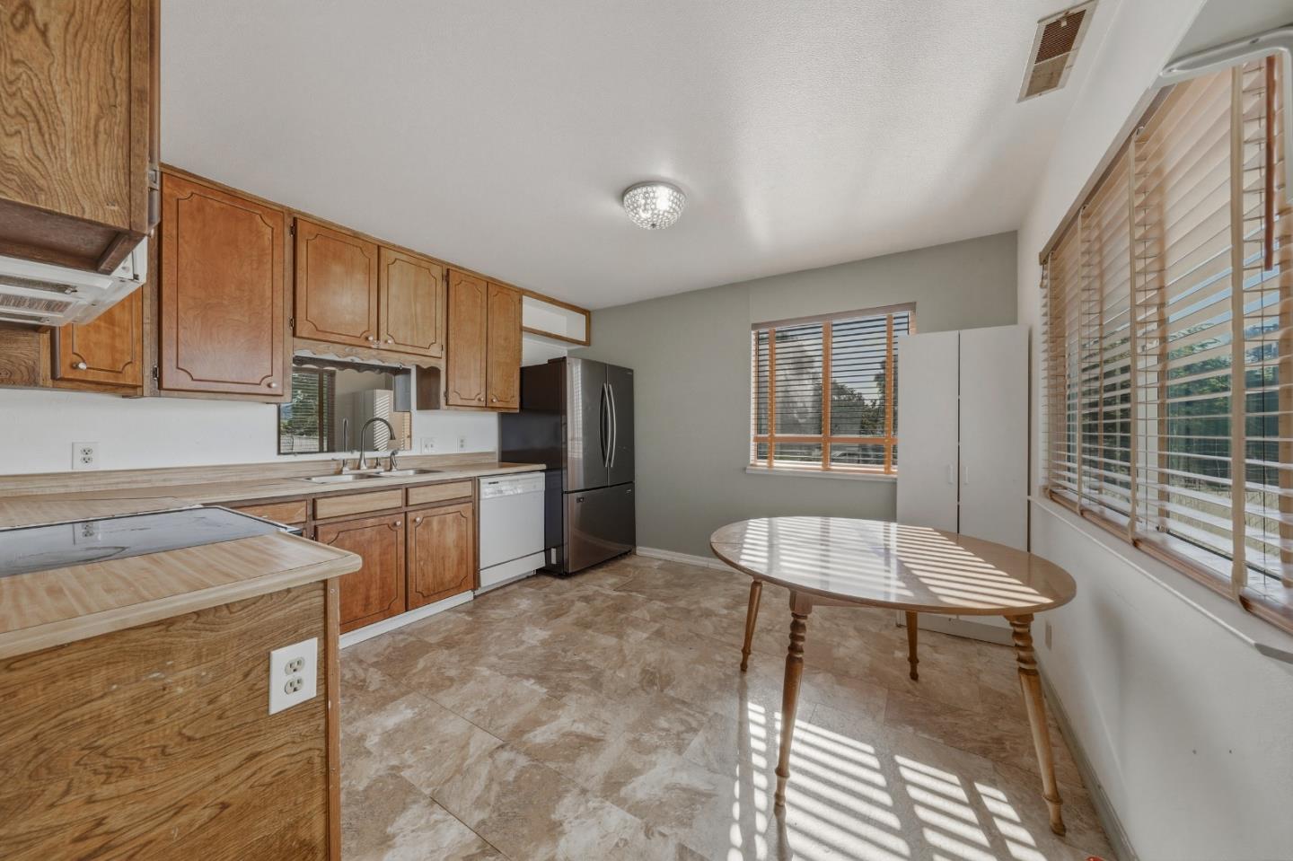 13590 Fair Oak Road Clearlake, CA 95422 - Photo 6 of 27 a kitchen with refrigerator and cabinets