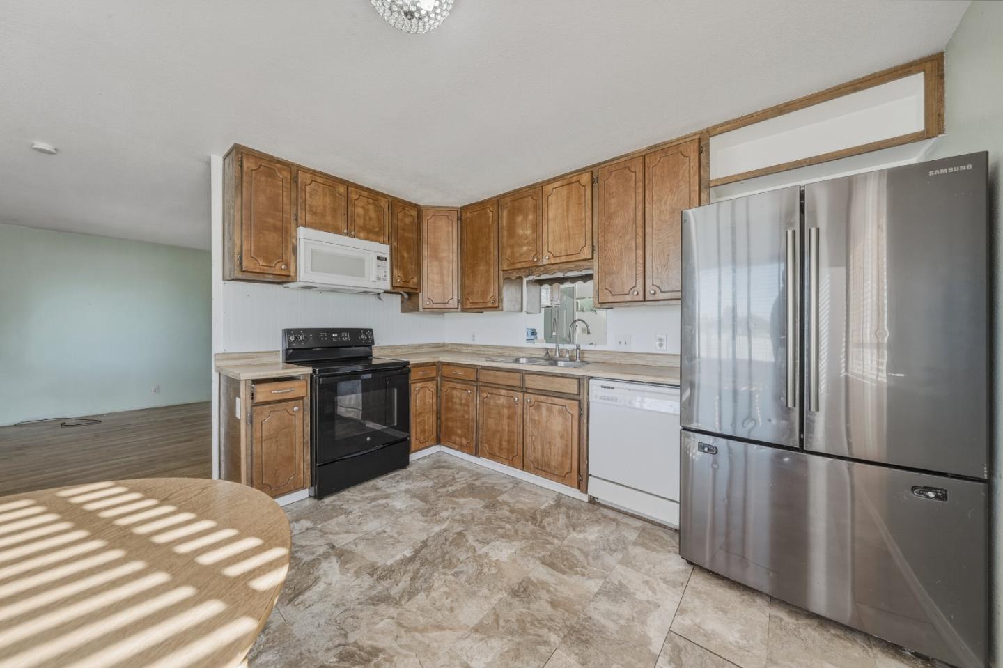 13590 Fair Oak Road Clearlake, CA 95422 - Photo 7 of 27 a kitchen with a refrigerator sink and stove