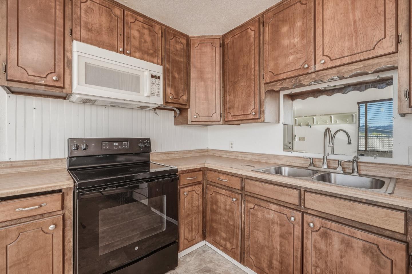 13590 Fair Oak Road Clearlake, CA 95422 - Photo 8 of 27 a kitchen with cabinets appliances a sink and a counter top space