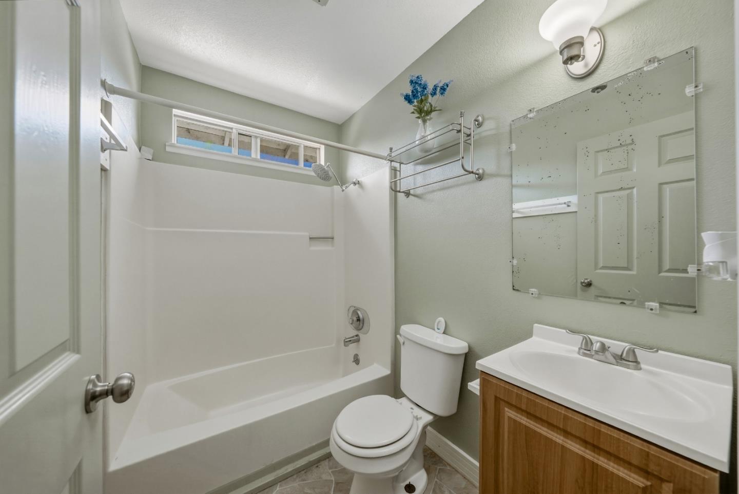 13590 Fair Oak Road Clearlake, CA 95422 - Photo 9 of 27 a bathroom with a sink a toilet and a large mirror