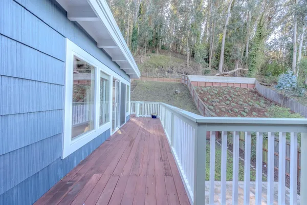 a view of a porch with wooden floor and stairs