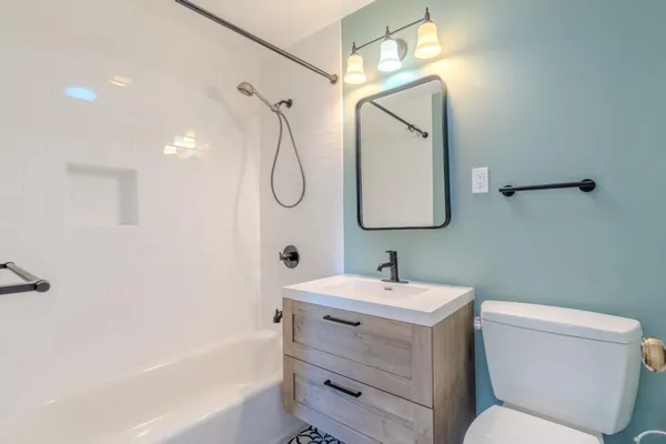 a view of a livingroom with wooden floor and stairs