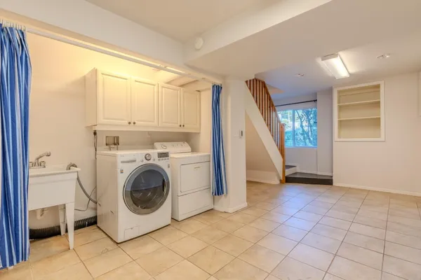 a view of empty room with cabinet and stairs