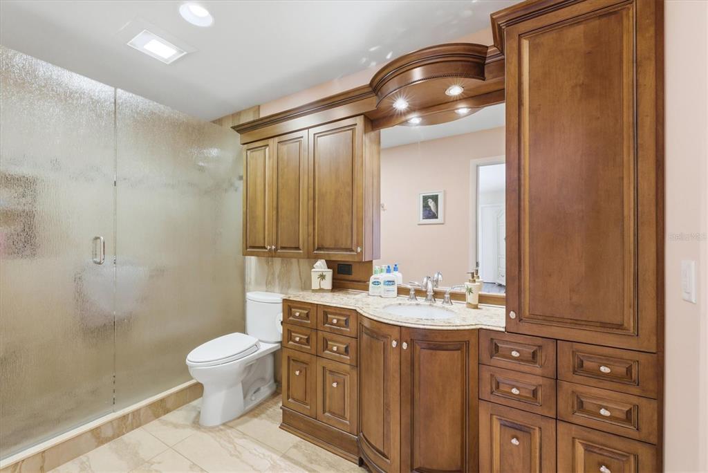 2729 North Beach Road, Unit 211 Englewood, FL 34223 - Photo 28 of 51 a bathroom with a sink a toilet and shower