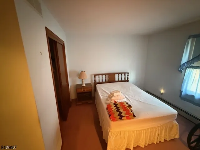 a bed sitting in a bedroom next to a window